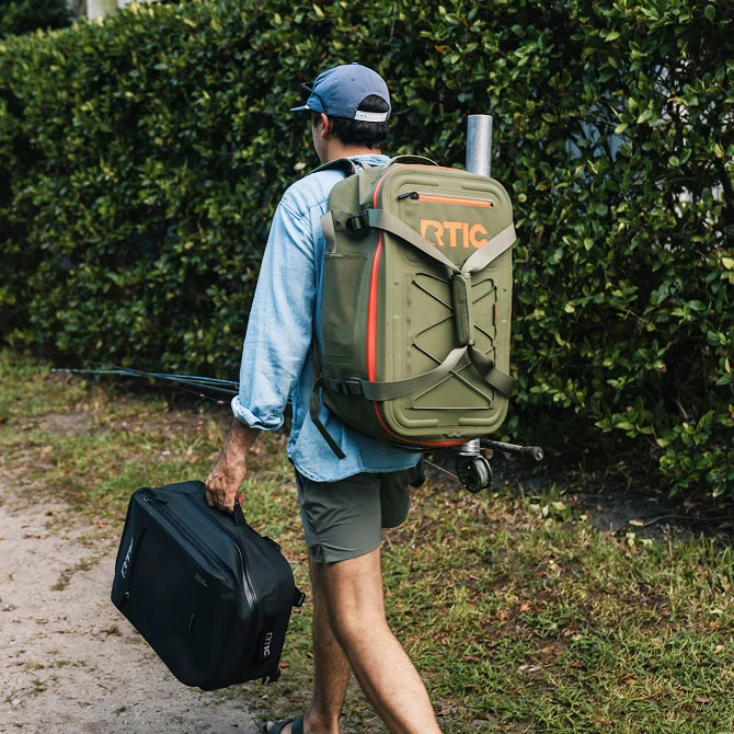 Man walking on a trail, carrying an Ultra-Dry Backpack on his back.